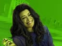 Tatiana Maslany as She-Hulk. She has green skin and big hair; the background behind her has a lime green wash over it (Credit: Marvel/Disney+)