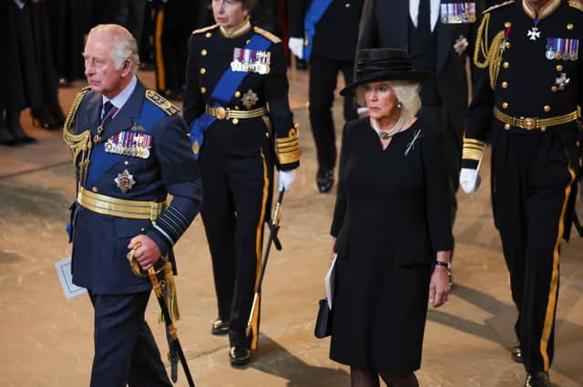 LONDON, ENGLAND - SEPTEMBER 14: King Charles III and Camilla, Queen Consort walk as procession with the coffin of Britain's Queen Elizabeth arrives at Westminster Hall from Buckingham Palace for her lying in state, on September 14, 2022 in London, United Kingdom. Queen Elizabeth II's coffin is taken in procession on a Gun Carriage of The King's Troop Royal Horse Artillery from Buckingham Palace to Westminster Hall where she will lay in state until the early morning of her funeral. Queen Elizabeth II died at Balmoral Castle in Scotland on September 8, 2022, and is succeeded by her eldest son, King Charles III. (Photo by Phil Noble - WPA Pool/Getty Images)