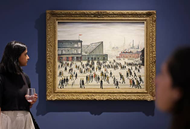 A visitor walks past "Going to the Match" by English artist LS Lowry from 1928, on display at a Christie's exhibition in Dubai on September 15, 2022