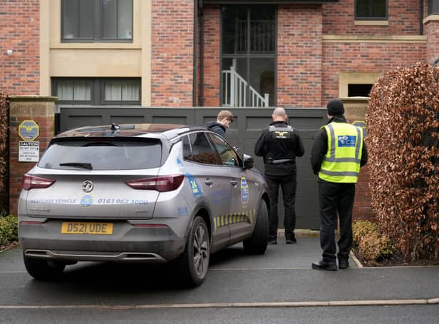 <p>Police officers standing outside Mason Greenwood’s house in February 2022.</p>