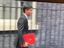 Rishi Sunak leaves Downing Street in 2020 with a burgundy coloured ring binder.