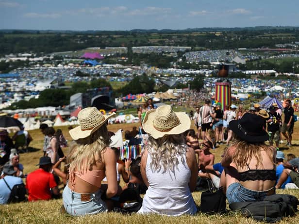 Festivalgoers enjoy the sun and warm weather as they attend Glastonbury 2022 (Photo: ANDY BUCHANAN/AFP via Getty Images)