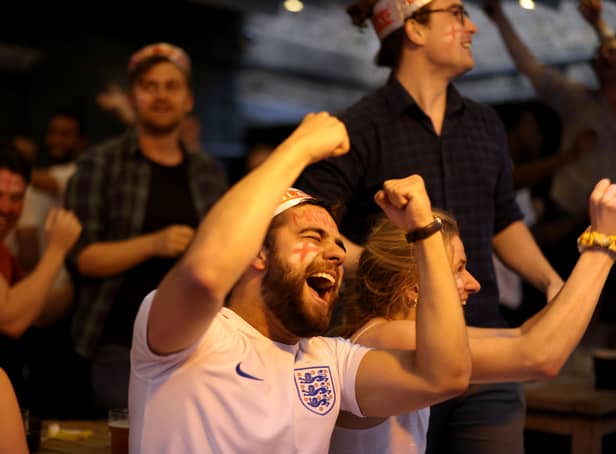 <p>Football fans celebrate while watching the live broadcast of the final of the 2020 UEFA European Championships between England and Italy in the Oxford Arms pub in Camden on July 11, 2021 in London.</p>