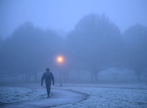 <p>A walker makes their way through fog on a frosty morning at Primrose Hill in north London. (Photo by Justin TALLIS / AFP) (Photo by JUSTIN TALLIS/AFP via Getty Images)</p>