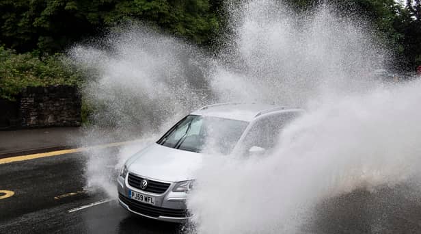 A car drives through floodwater (Photo by Matthew Horwood/Getty Images)