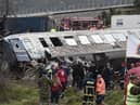 Police and emergency crews search wreckage after a train accident in the Tempi Valley near Larissa, Greece, March 1, 2023. - At least 32 people were killed and another 85 injured after a collision between two trains caused a derailment near the Greek city of Larissa late at night on February 28, 2023, authorities said. A fire services spokesman confirmed that three carriages skipped the tracks just before midnight after the trains -- one for freight and the other carrying 350 passengers - collided about halfway along the route between Athens and Thessaloniki. (Photo by Sakis MITROLIDIS / AFP) (Photo by SAKIS MITROLIDIS/AFP via Getty Images)
