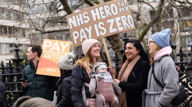 Demonstrators hold placards as they take part in a protest by junior doctors. Picture: NIKLAS HALLE’N/AFP via Getty Images