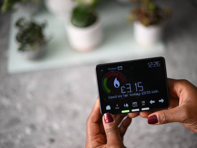 Samantha Pierre-Joseph shows her smart meter indicating how many kWh (kilowatt-hour) she has used already in one day, and how much it has cost her, in her house in London, on December 13, 2022. 