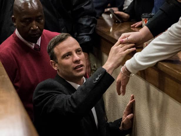 Olympic athlete Oscar Pistorius holds the hand of a relative after sentencing at the High Court on July 6, 2016 at the High Court in Pretoria, South Africa. Pistorius was sentenced to six years in prison for the murder of girlfriend Reeva Steenkamp at their home in 2013.