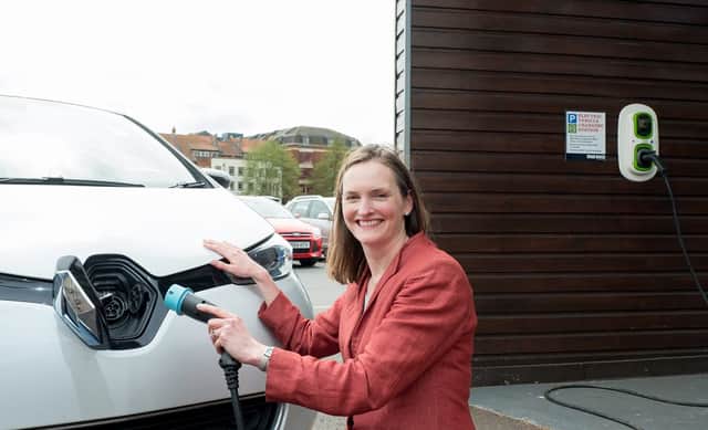Angela Terry with EV charger to be a common sight outside all new build homes (photo: @JonCraig_Photos)