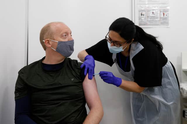 Martin Gillibrand, 45, receives an AstraZeneca vaccination at a Boots pharmacy (Photo by Hollie Adams/Getty Images)