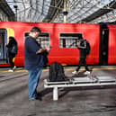 Commuters walk past a train stopped at a platform in Waterloo Station in London, during a national strike day, on February 1, 2023.