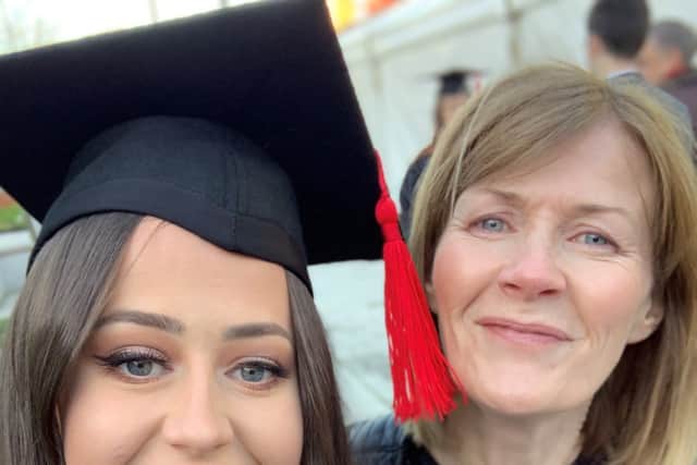 Eve as an adult at her daughter's graduation