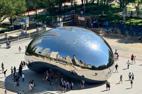 Chicago cityscape reflected in iconic Cloud Gate monument, known as 'The Bean'