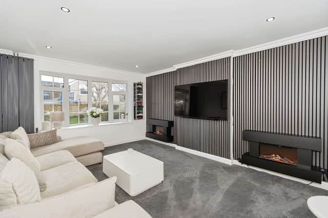 A sizeable front window fills the well-proportioned lounge with natural light, creating a welcoming everyday reception space