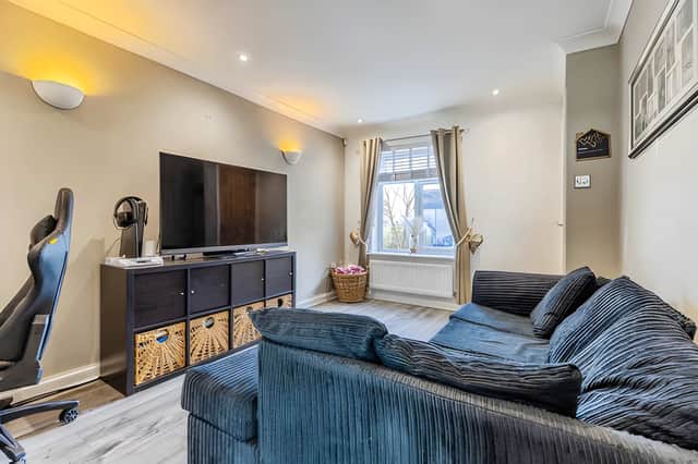 The spacious lounge creates a welcoming main living area and flows naturally towards the kitchen
