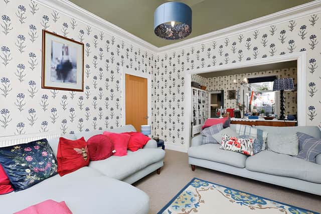A characterful fireplace and log-burning stove give the main living room a cosy focal point