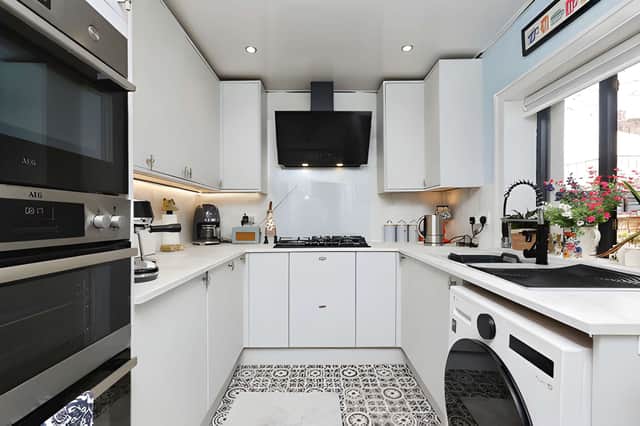 A contemporary fitted kitchen with integrated appliances brings practical modern touches to a home that retains its period-style character