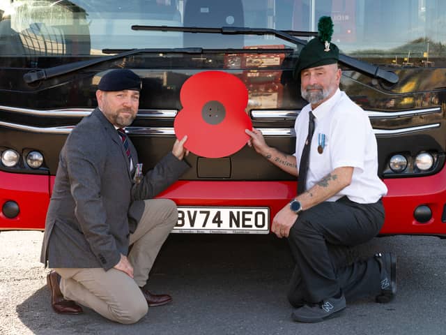 Transdev colleagues who are former Armed Forces personnel with a poppy in front of a bus, operated by Transdev, for the Poppy Appeal 2026 campaign renewal