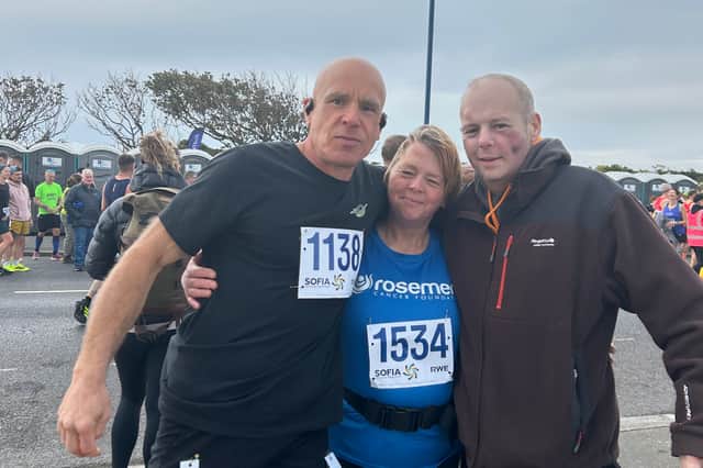 Tracy at the finish line of the Redcar half marathon with her brother Denis (right) and husband Matt
