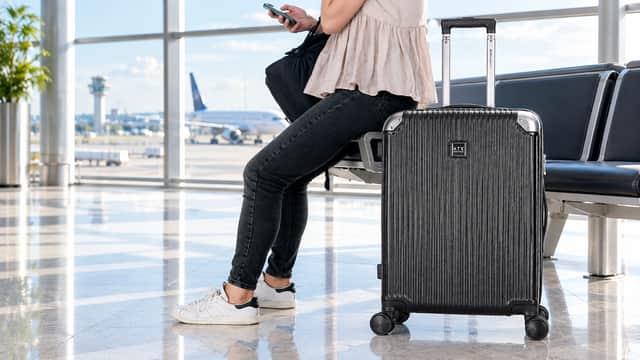 The Jet Black ATX Luggage 21-inch hard-shell cabin suitcase has four spinner wheels and telescopic handle.