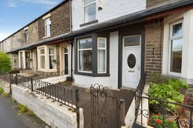 The mid-terrace property on Rossendale Road is offered for £115,000, with on-street parking available at the front.