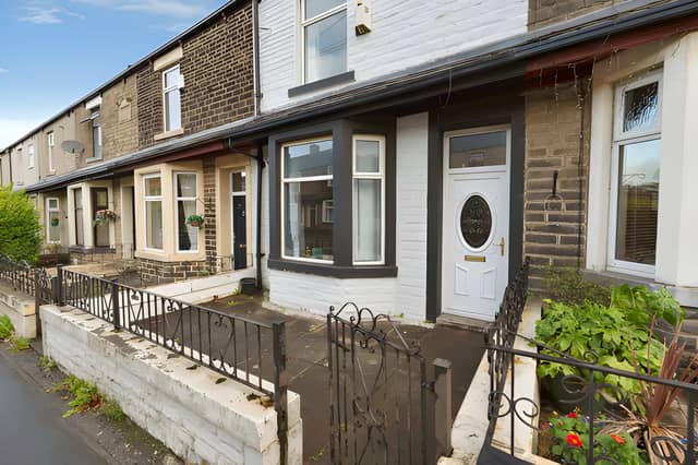 The mid-terrace property on Rossendale Road is offered for £115,000, with on-street parking available at the front.