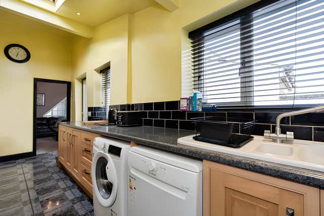 The large kitchen offers room for cooking and everyday use, complementing the home's two separate reception rooms.