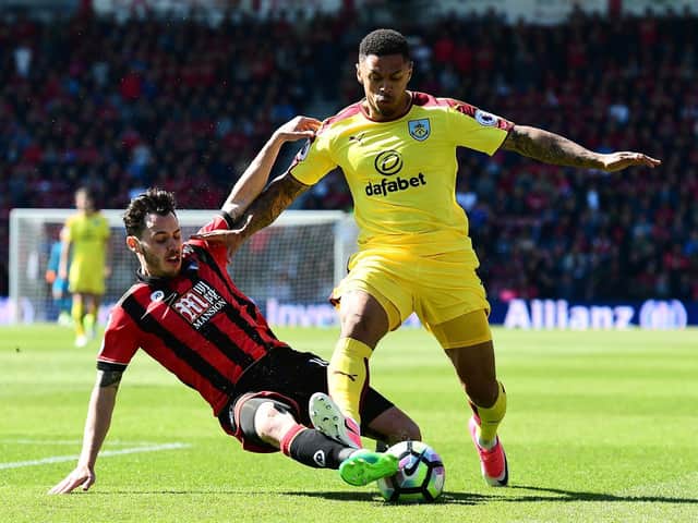 Former Burnley striker Andre Gray rides the challenge of AFC Bournemouth's Charlie Daniels