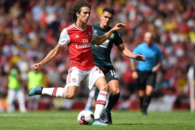 Matteo Guendouzi of Arsenal is tackled by Ashley Westwood of Burnley during the Premier League match between Arsenal FC and Burnley FC at Emirates Stadium