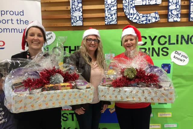 Melanie (centre) collects the first lot of donations for her NHS hamper appeal from Burnley Tesco store manager Caroline O'Hanlon (left) and community champion Billie-Jean Horne.