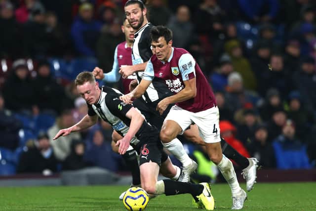 BURNLEY, ENGLAND - DECEMBER 14: Sean Longstaff of Newcastle United is brought down by Jack Cork of Burnley during the Premier League match between Burnley FC and Newcastle United at Turf Moor on December 14, 2019 in Burnley, United Kingdom. (Photo by Jan Kruger/Getty Images)