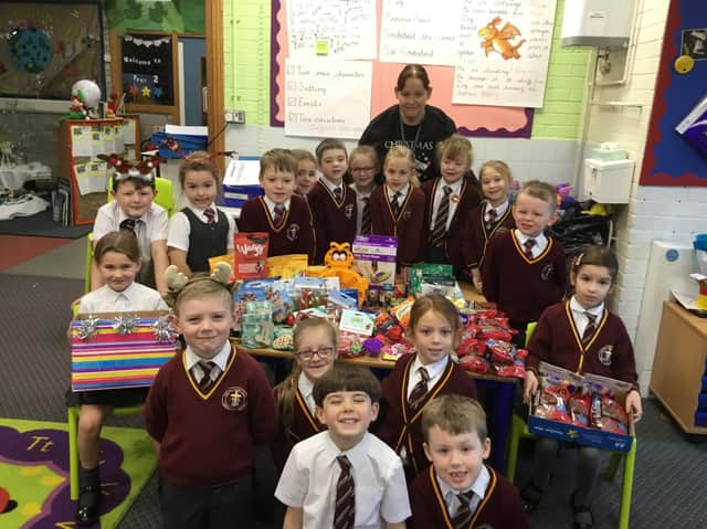 Mrs McNally with the year one pupils and some of the gifts and items they have collected.