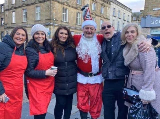 Mark Hanson (fourth from left) and Pastor Mick Fleming (second from right) with helpers at the Christmas festival.