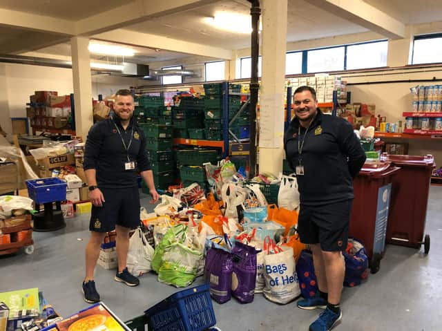 Blessed Trinity RC College teachers Mr Isherwood and Mr Holding with some of the thousands of items pupils and their families donated for the local food bank.