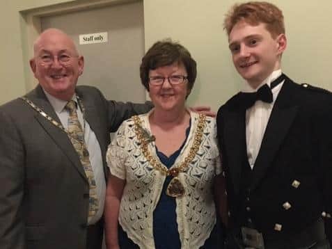 The Mayor of Burnley Mrs Anne Kelly and her consort Mr John Kelly with the piper Richard Clough at the Burns Night.