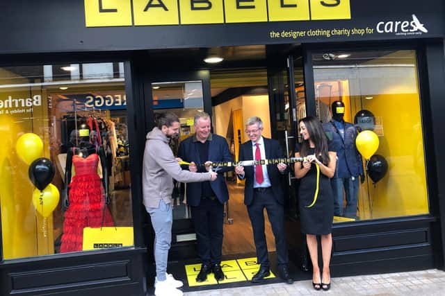 Jay Rodriguez officially opens Labels, watched on by CARES founder and Burnley FC director John Banaszkiewicz, Burnley chief executive Mick Cartklede and Labels retail manager Sarah Walker.
