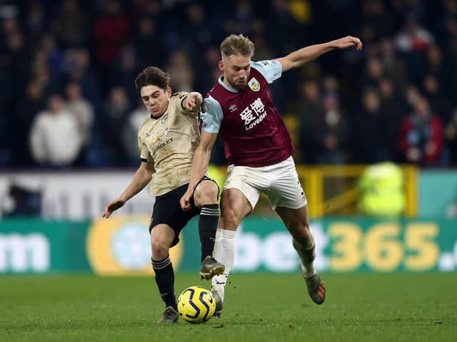 Burnley's Charlie Taylor forces his way past Daniel James in victory over Manchester United at Old Trafford