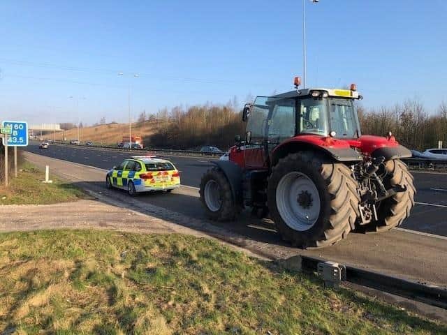 The tractor on the hard shoulder.