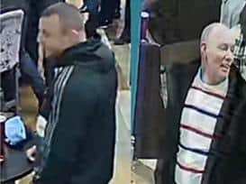 Police want to speak to the two men pictured after a large-scale fight between Burnley FC and Newcastle United fans broke out at a pub in Burnley. (Credit: Lancashire Police)