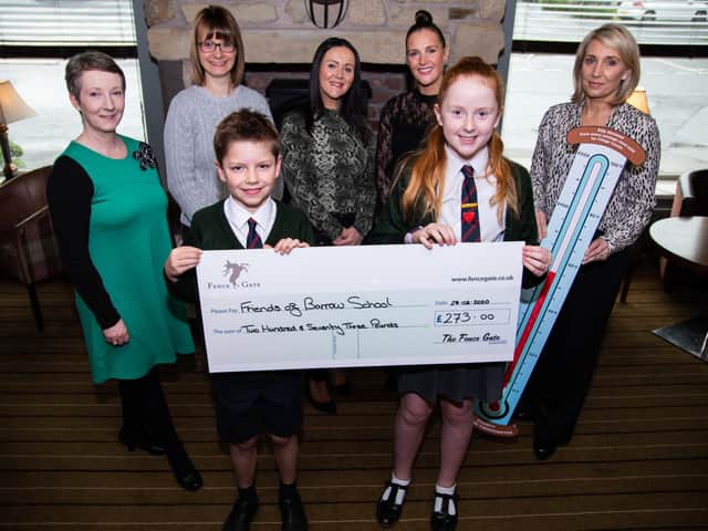 Charlie Smith and Bea Wilson from Friends of Barrow Primary School with the cheque presented to the school. (l-r) Mrs Janet Halstead (Assistant Headteacher), Laura Clarkson, Donna Clarkson, Tracey Board (Friends of Barrow), Keeley Beaumont (Director, Eagle at Barrow)