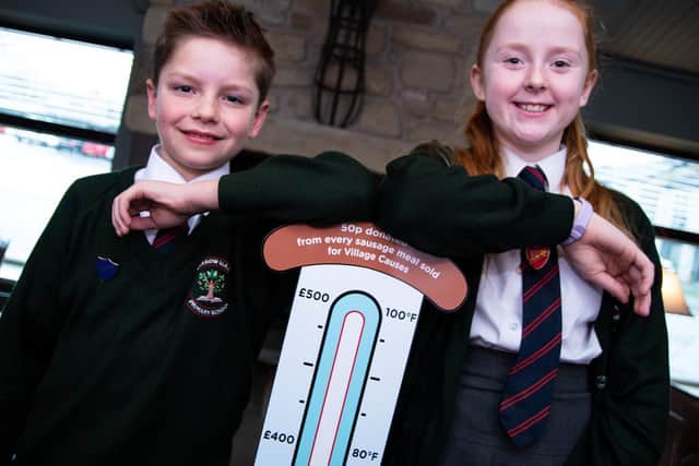 Charlie Smith and Bea Wilson from Friends of Barrow primary school with the sausage-ometer.