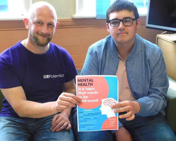 Chris Smith and Simon Crabtree with the mental health poster designed by young people in Wyre (pictured in 2018)