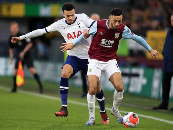 Tottenham Hotspur midfielder Dele Alli vies with Burnley midfielder Dwight McNeil during the English Premier League football match at Turf Moor on March 7, 2020. (Photo by LINDSEY PARNABY/AFP via Getty Images)