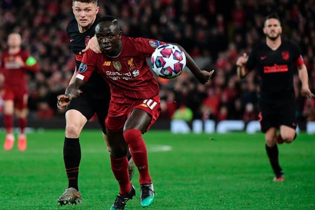 Atletico Madrid's Kieran Trippier vies for possession with Liverpool forward Sadio Mane at Anfield during their encounter in the Champions League