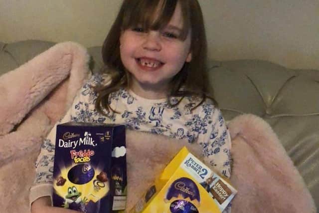 Colouring competition winner Lucia-Grace Brierley with her Easter egg prizes.