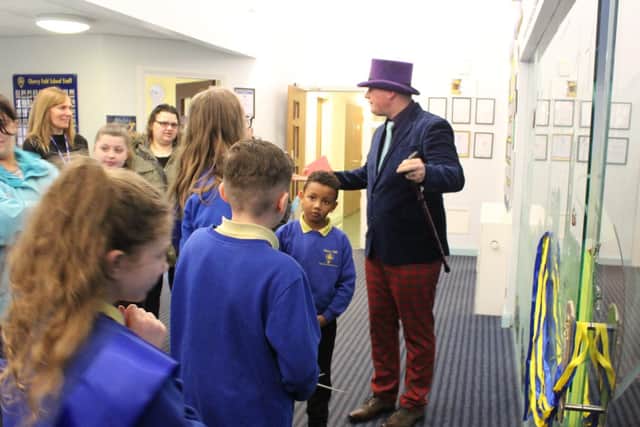 Staff and children gather with 'Willy Wonka' for the official opening of the new library at Cherry Fold Primary School in Burnley.