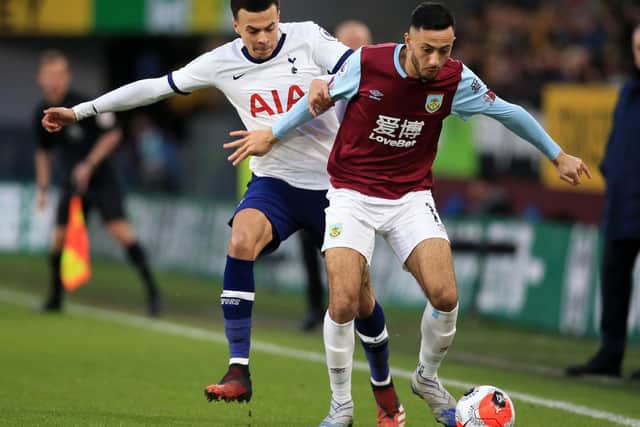 Burnley winger Dwight McNeil shields the ball from Spurs midfielder Dele Alli at Turf Moor