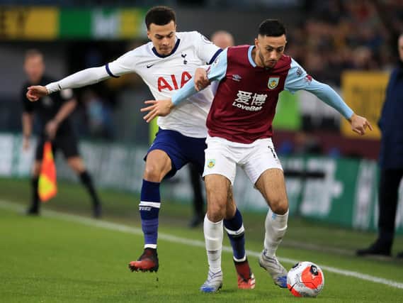 Burnley winger Dwight McNeil shields the ball from Spurs midfielder Dele Alli at Turf Moor