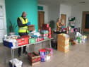 Rashid Hussain, Project Manager for Inspiring Grace, and Lauren Jackson from Pendle Leisure Trust, put food parcels together for Pendle residents